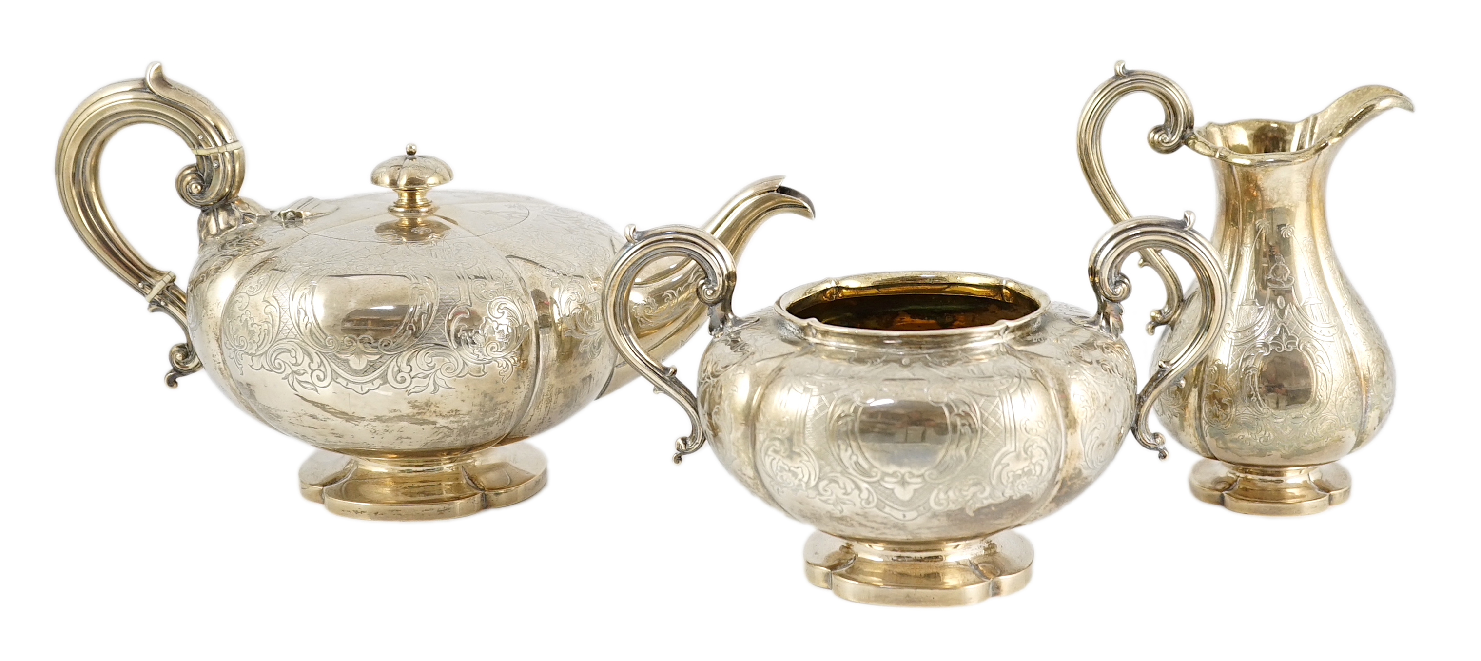 A Victorian silver three piece melon shaped tea set, by Charles Reily & George Storer